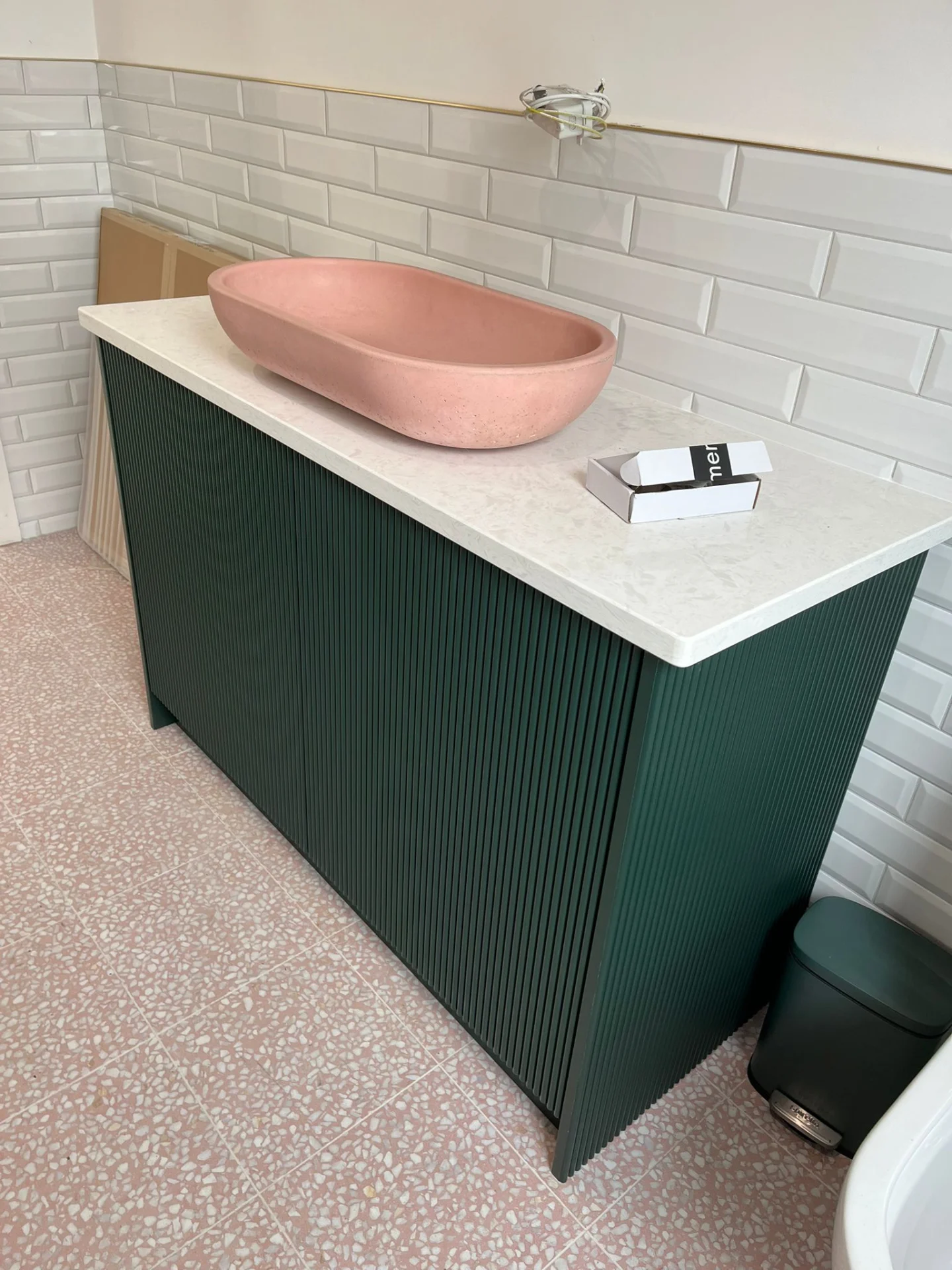 Green fluted bathroom vanity with drawers and bespoke fitted finish.